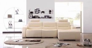 Modern living room with a cream L-shaped sectional sofa and minimalist decor.
