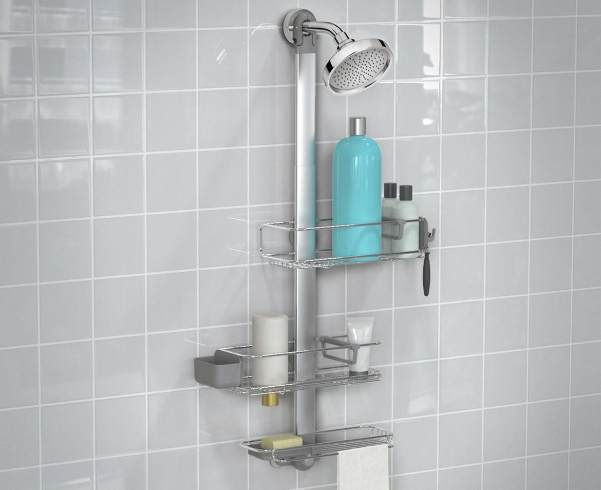 A silver shower caddy hangs from a showerhead, holding bath products on a tiled wall.