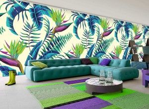 Modern living room featuring vibrant tropical leaf wallpaper and a large teal sectional sofa.