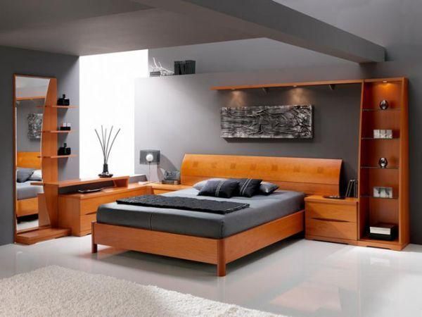 Modern bedroom with light wooden bed, matching nightstands, and dark grey bedding.