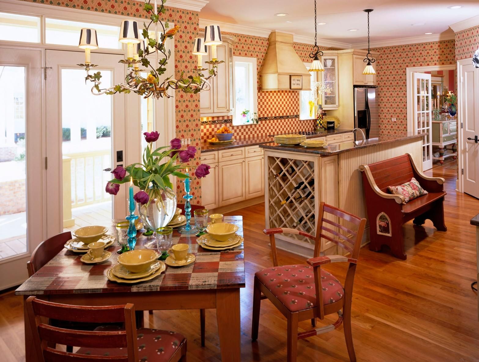 Vibrant dining room with set table and floral centerpiece opening into a bright kitchen.