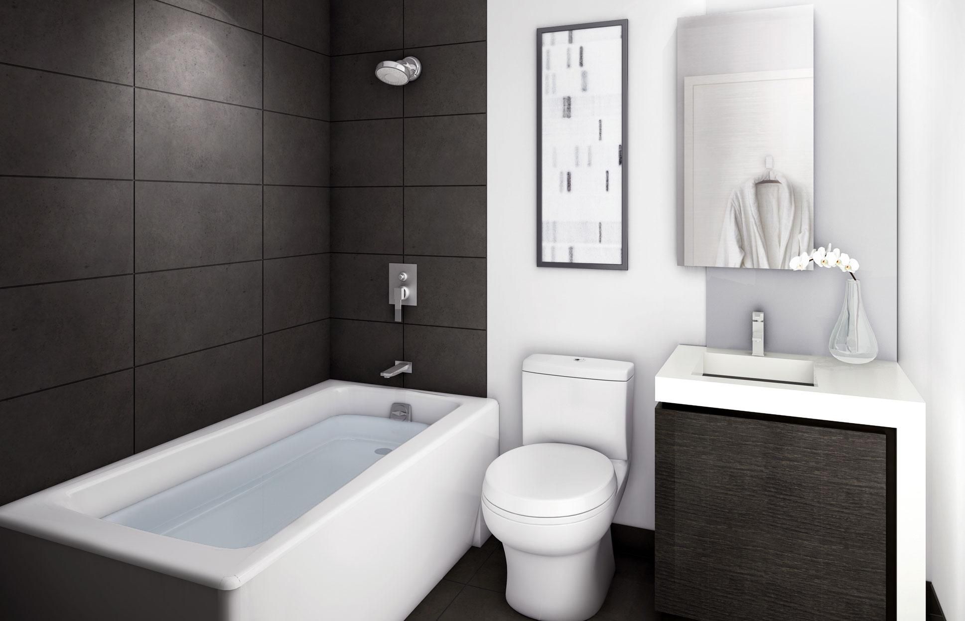 Modern bathroom with dark tiled walls, white bathtub, toilet, and sleek vanity.