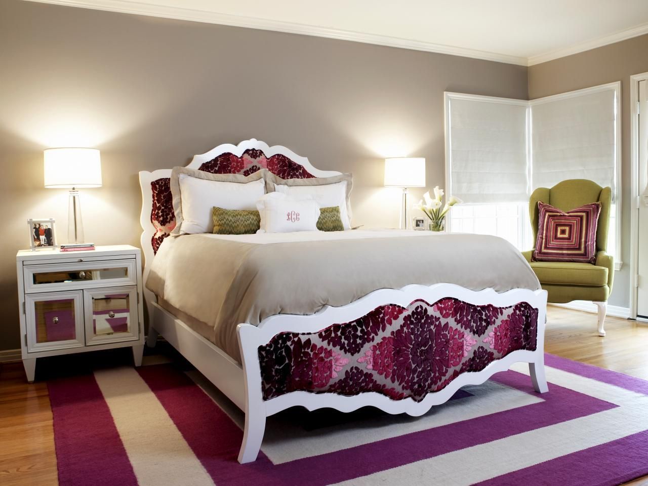 Stylish white bed features a bold purple and white patterned headboard and footboard.