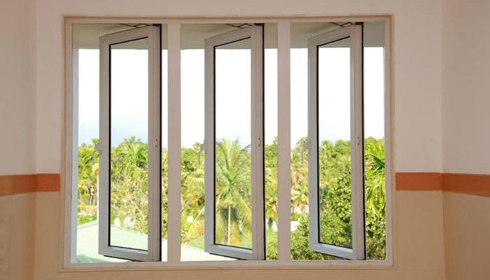 Three open casement windows offer a view of a lush green landscape outside.